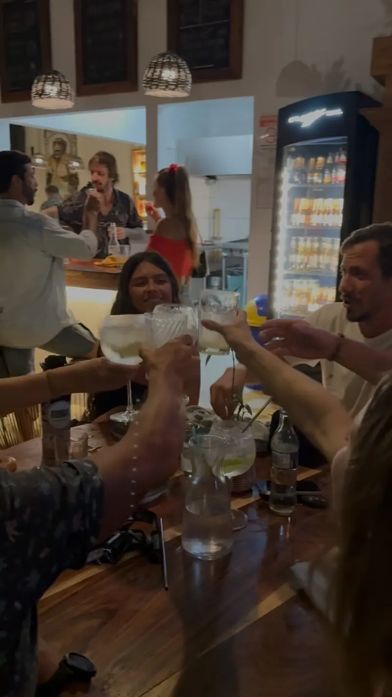 Friends toasting at the restaurant's bar