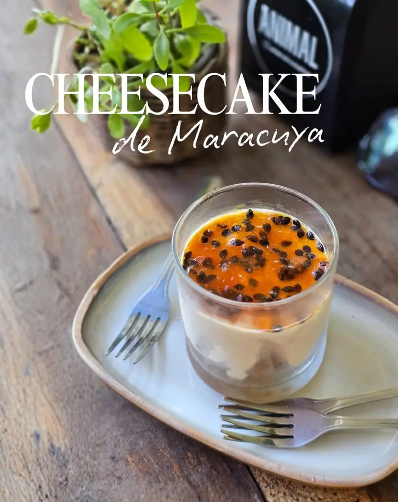 Passion fruit cheesecake in a glass on a wooden table