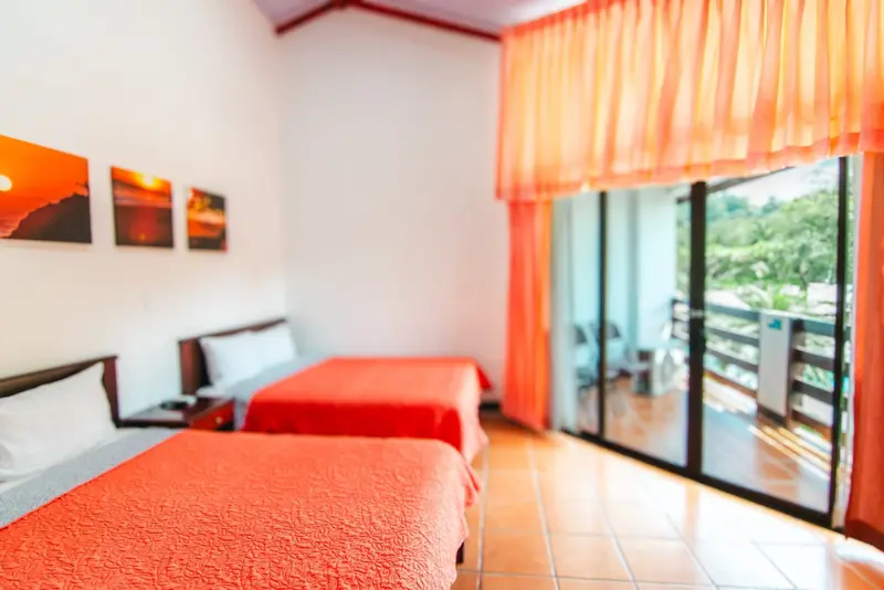 Standard room with beds and a balcony door
