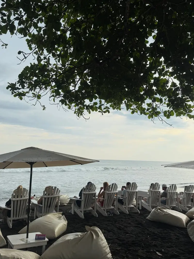 Beach chairs and beanbags on the sand at Vida Hermosa, facing the ocean
