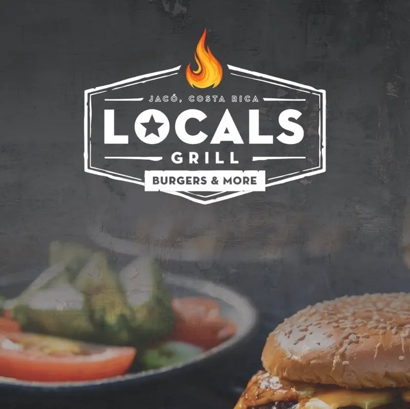 Hamburguesa de Locals Grill servida con guarnición de aguacate y tomate
