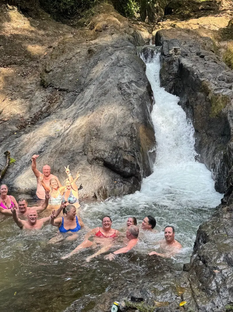 Grupo disfrutando de una cascada natural