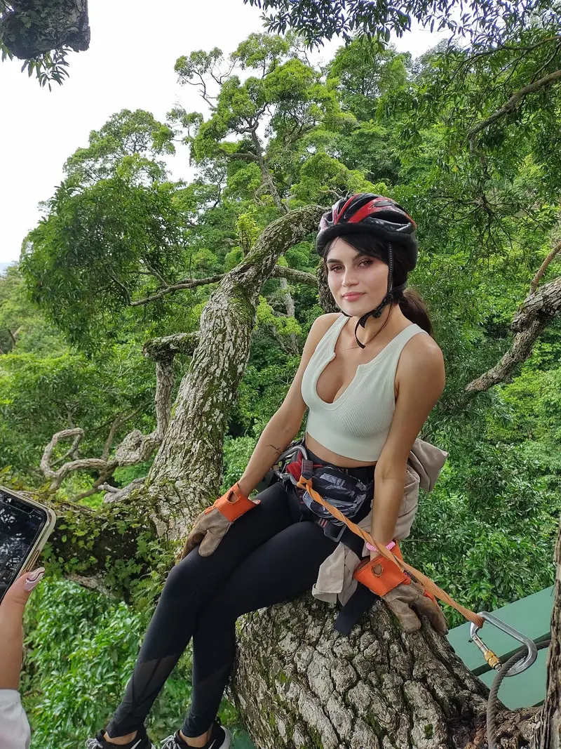 Guest sitting on a tree branch during the tour