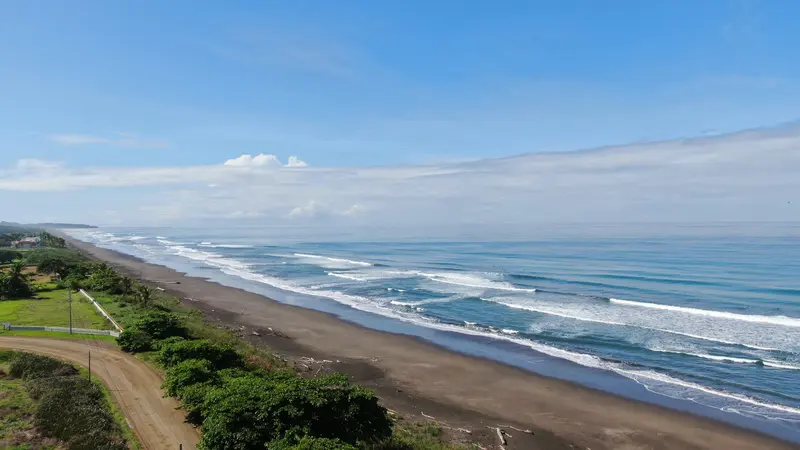 Sandy beach with breaking waves, seen from above