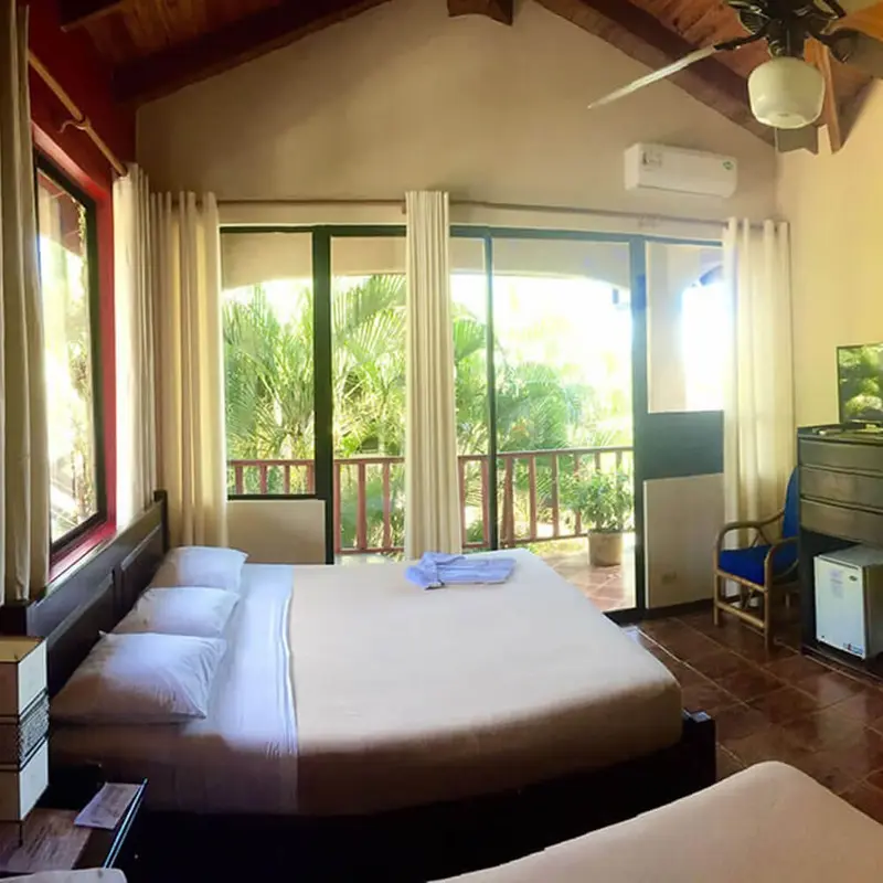 Room with a double bed and balcony door