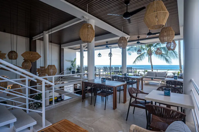 Interior de Ozeano con lámparas de ratán y vista al mar