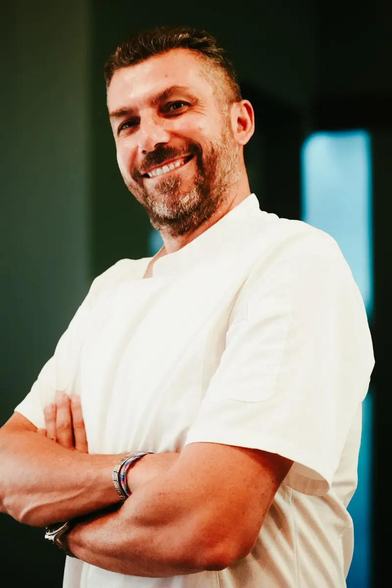 El chef Luigi Tumminello con chaqueta blanca y los brazos cruzados