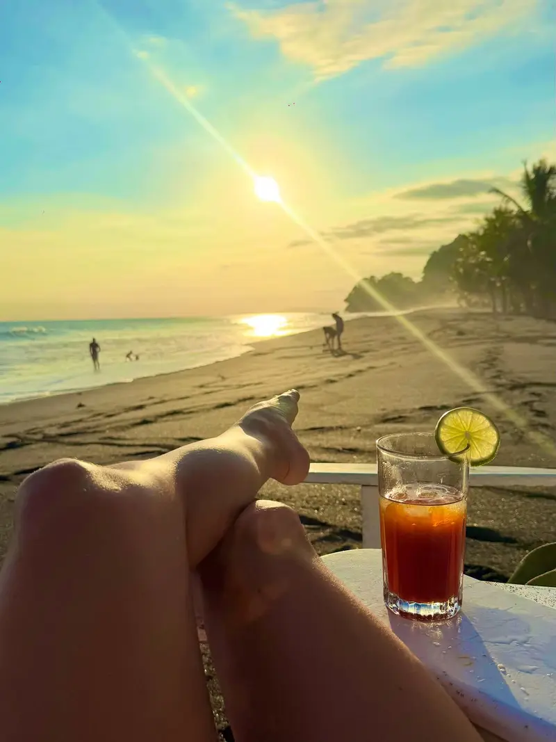 Sunset over the beach as seen from Vida Hermosa, drink in hand