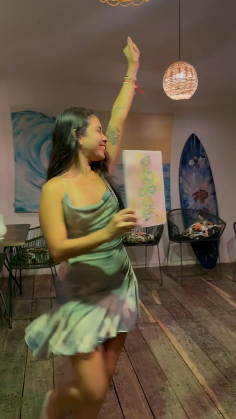 Guest dancing in the dining room decorated with surfboards