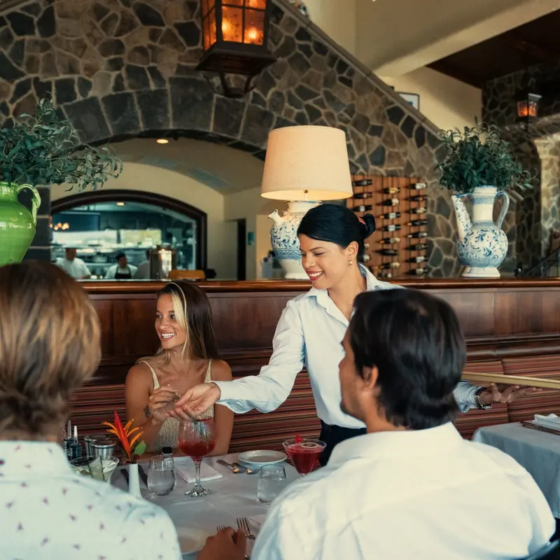 Mesero atendiendo una mesa en el comedor de Lanterna